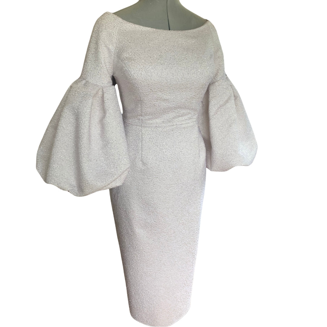 A luxurious boat neck fitted and tailored dress offering a unique twist with an oversized volume cuff.