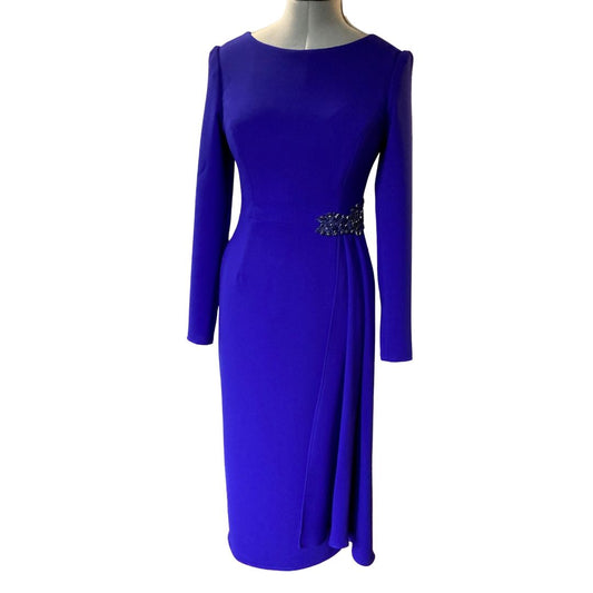 Sarah Side Drape in Byzantine Purple colour. This dress is a Classic and Elegant, tailored Dress, ideal for a mother of the Bride/Groom. Simple sleeve and neckline with a flattering side drape anchored with a Jewelled applique