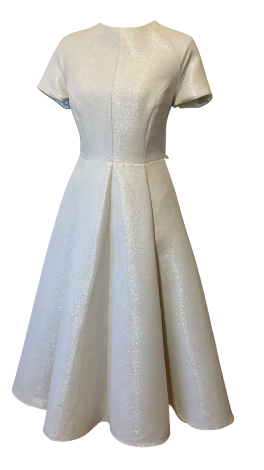 Vintage Inspired High Neck Dress in an Ivory coloured Jacquard with a Beautiful Metallic shimmer. The full swing skirt and nipped in waist are very flattering while the high neckline adds a demure elegance. The Pearl Cluster buttons highlighting the back zip adding extra luxury. 