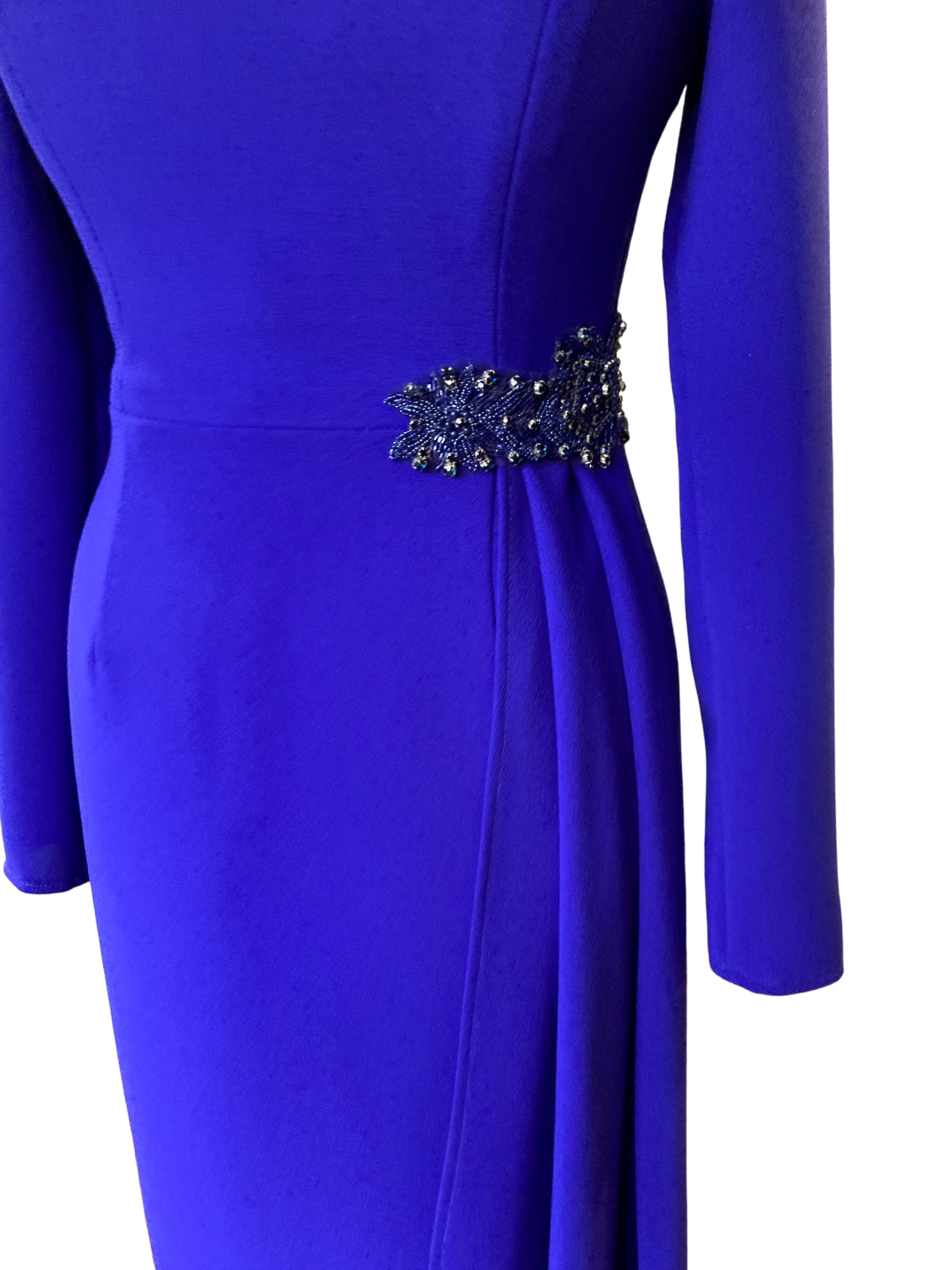 Sarah Side Drape in Byzantine Purple colour. This dress is a Classic and Elegant, tailored Dress, ideal for a mother of the Bride/Groom. Simple sleeve and neckline with a flattering side drape anchored with a Jewelled applique.